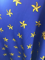 Load image into Gallery viewer, Yellow Starfish on Royal Blue Background Nylon Spandex Fabric

