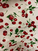 Load image into Gallery viewer, Poly cotton Red cherry’s on white fabric sold  by yard  58" wide

