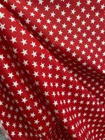 Load image into Gallery viewer, White stars on red Poly cotton fabric sold by yard  58" wide
