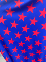 Load image into Gallery viewer, Red stars on blue Spandex trixot 4 way stretch fabric 58" wide

