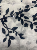 Load image into Gallery viewer, Black floral flocking on white sparkling orgaza fabric 45” wide
