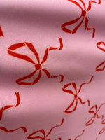 Load image into Gallery viewer, Red bows on pink spandex 4  way  fabric by the yard
