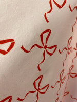Load image into Gallery viewer, Red bows on ivory spandex 4  way  fabric by the yard
