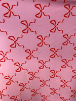 Load image into Gallery viewer, Red bows on pink spandex 4  way  fabric by the yard
